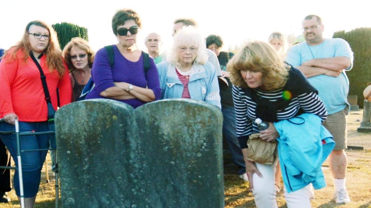 
 Julie Hildebrandt, right, of Anacortes, leans in for a closer look at a double tablet stone during an August 2015 tour at Green Hills Memorial Cemetery in Burlington.
