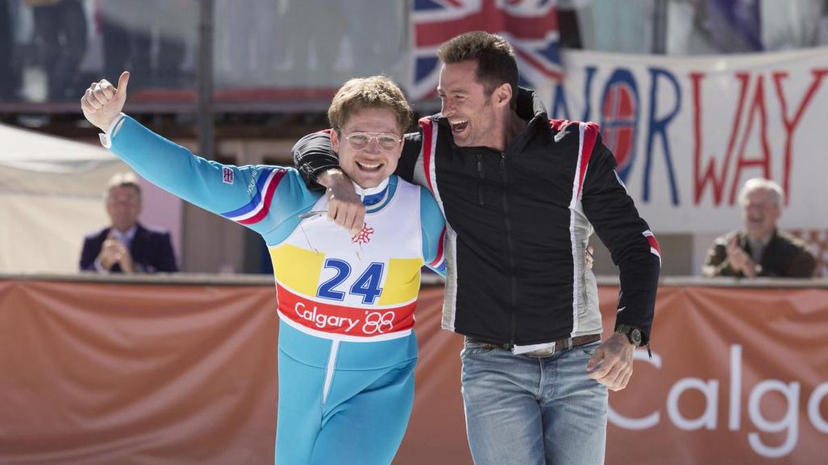 Hugh Jackman plays Bronson and Taron Egerton is Eddie in “Eddie the Eagle.”