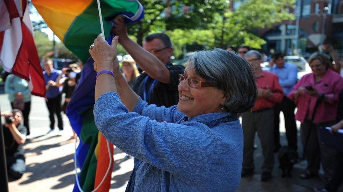 
Bellingham Mayor Kelli Linville raises the rainbow pride flag, placed below the American flag, kicking off the annual Bellingham Pride Festival in 2013.
