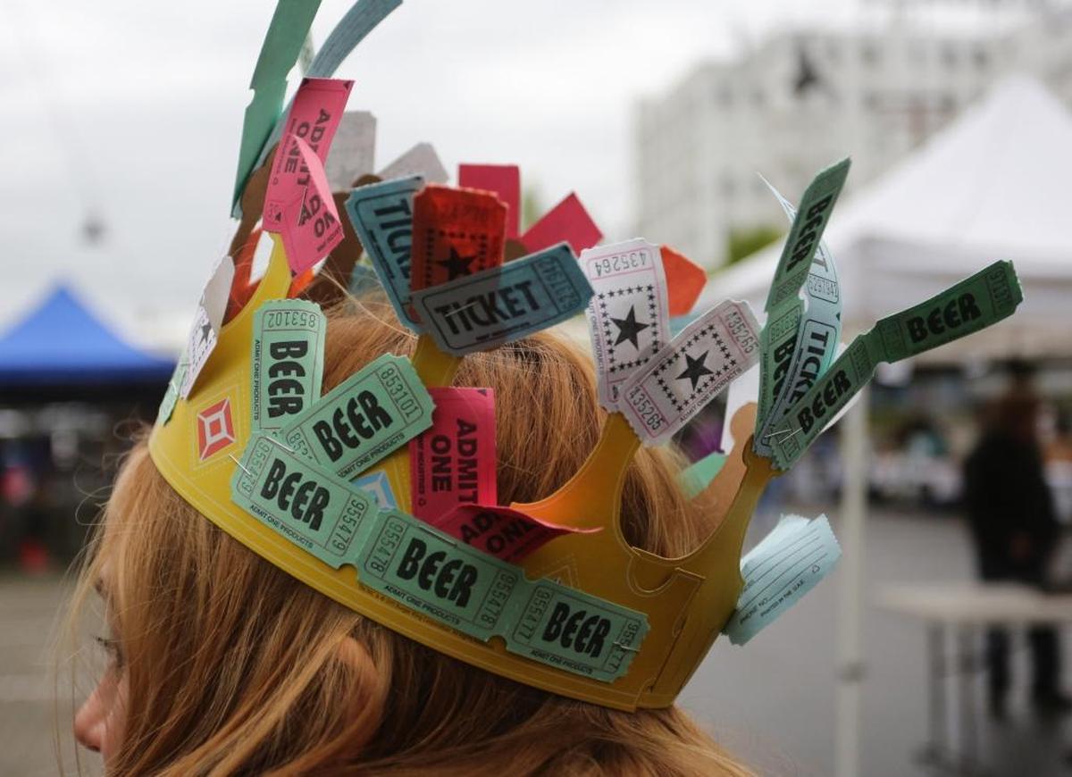 A woman wears a crown of drink tickets during April Brews Day, a fundraiser for the Max Higbee Center, in 2013 at the Depot Market Square in Bellingham.
