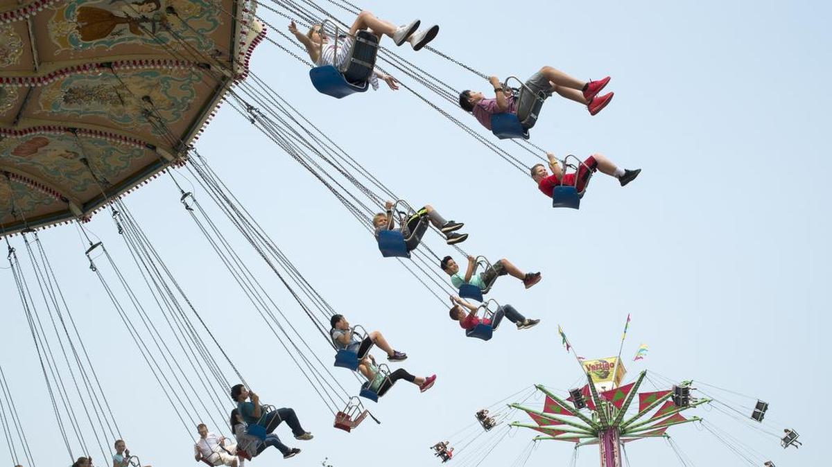 Fairgoers ride the Wave Swinger, left, and the Vertigo at the Northwest Washington Fair in this 2018 file photo.
