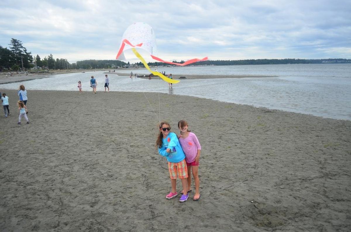 Children fly a hand-made kite in Birch Bay at the International Sea and Sky Festival in 2013.