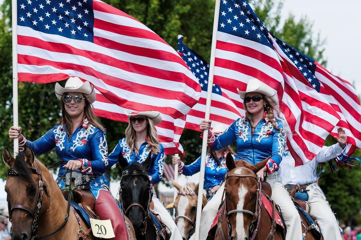Members of the Rodeo Cowgirls Drill Team entertain the crowd during the Old Fashioned Fourth of July parade in downtown Blaine in 2014.
