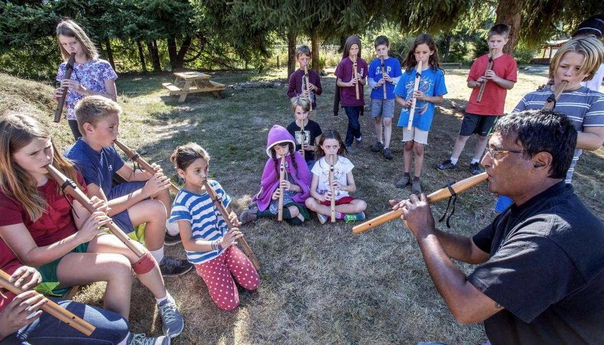 Peter Ali improvises a song with students on their Plains Indian-style flutes at the Olympia Waldorf School in 2014. He’ll be among the performs at Orca Fest.