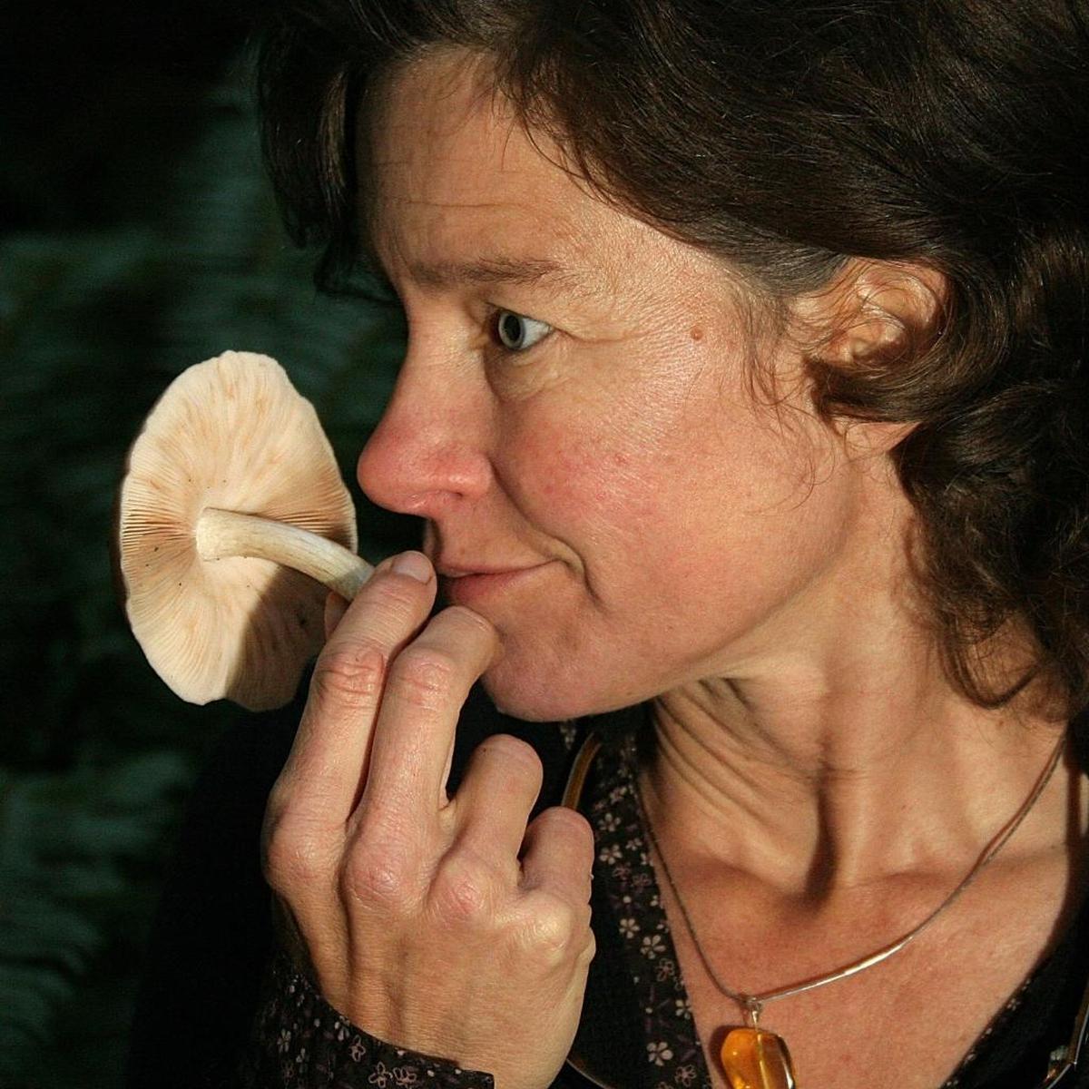 Northwest Mushroomers Association member Erin Moore sniffs the edible deer mushroom.