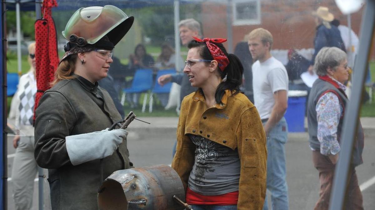 Bellingham Technical College’s Andrea Schuman and Samantha Shields discuss their project for their team Split Endz during the BTC Welding Rodeo in 2010.