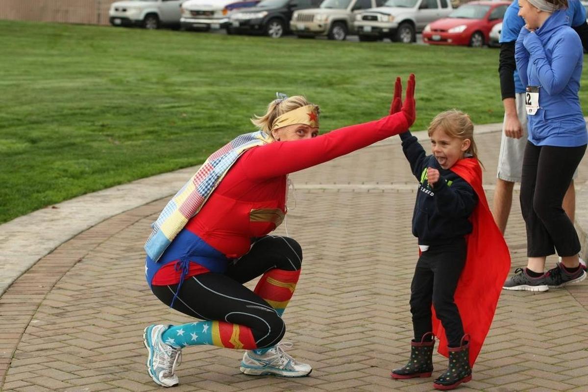 Participants celebrate a recent Everyday Superheroes run/walk.