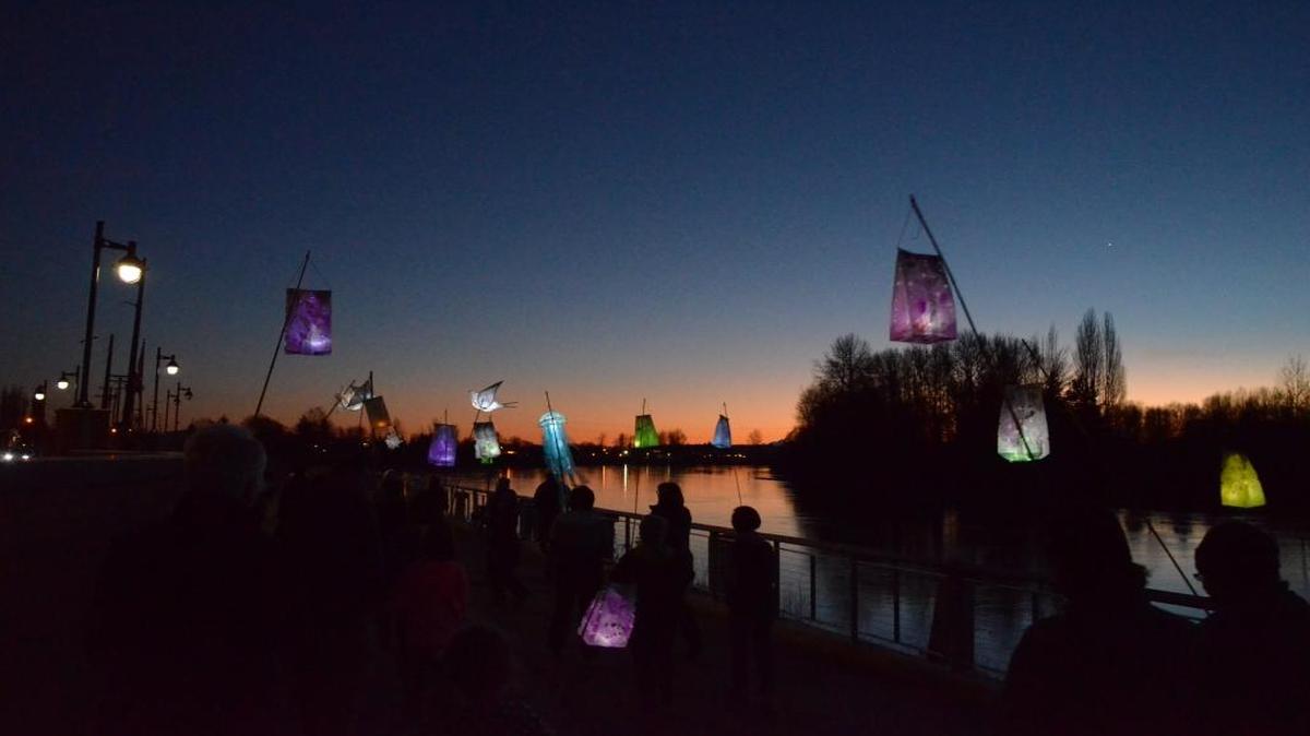 Participants carry lanterns and luminaries during the Illuminight Winter Walk along the Skagit River in Mount Vernon in January 2015.