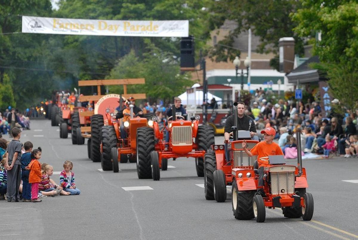 Members of the Puget Sound Antique Tractor Club are shown in the 104th annual Farmers Day Parade in June 2013.
