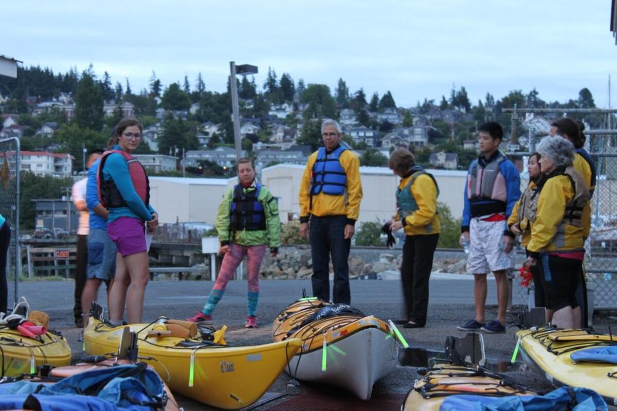 Participants in a 2016 bioluminescence tour prepare to paddle into Bellingham Bay.