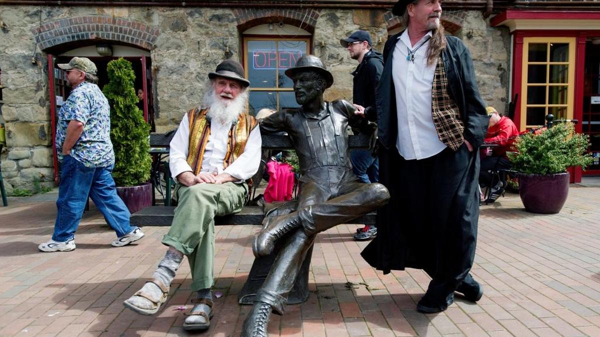 Participants dress as the Fairhaven historicaol icon “Dirty Dan” Harris near the namesake statue statue on the Village Green during the 13th annual Dirty Dan Harris Festival in in 2015.