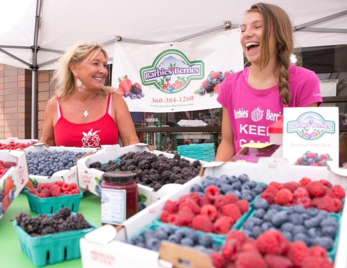 Barb Kraght, left, and Kiya Levin of Barbies Berries are shown at their booth during the Northwest Raspberry Festival in 2014.