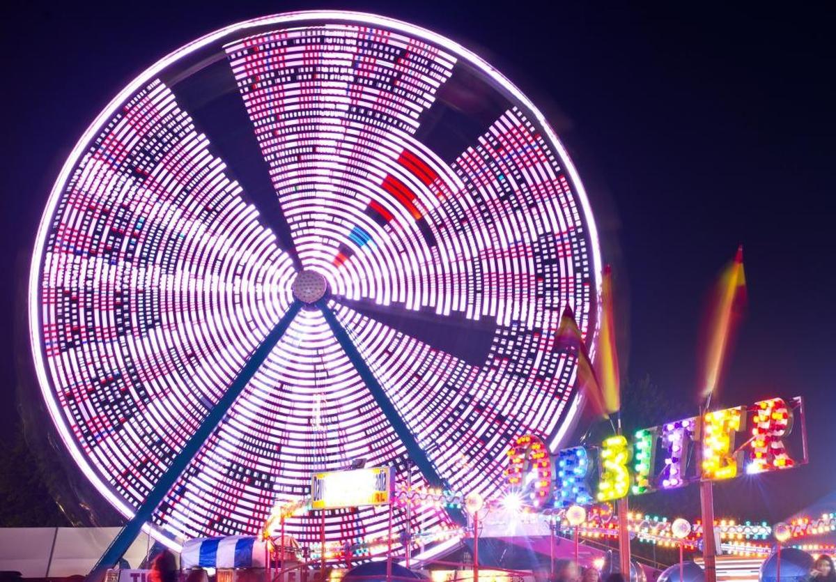 Carnival rides shine at night during the Northwest Washington Fair in 2014.