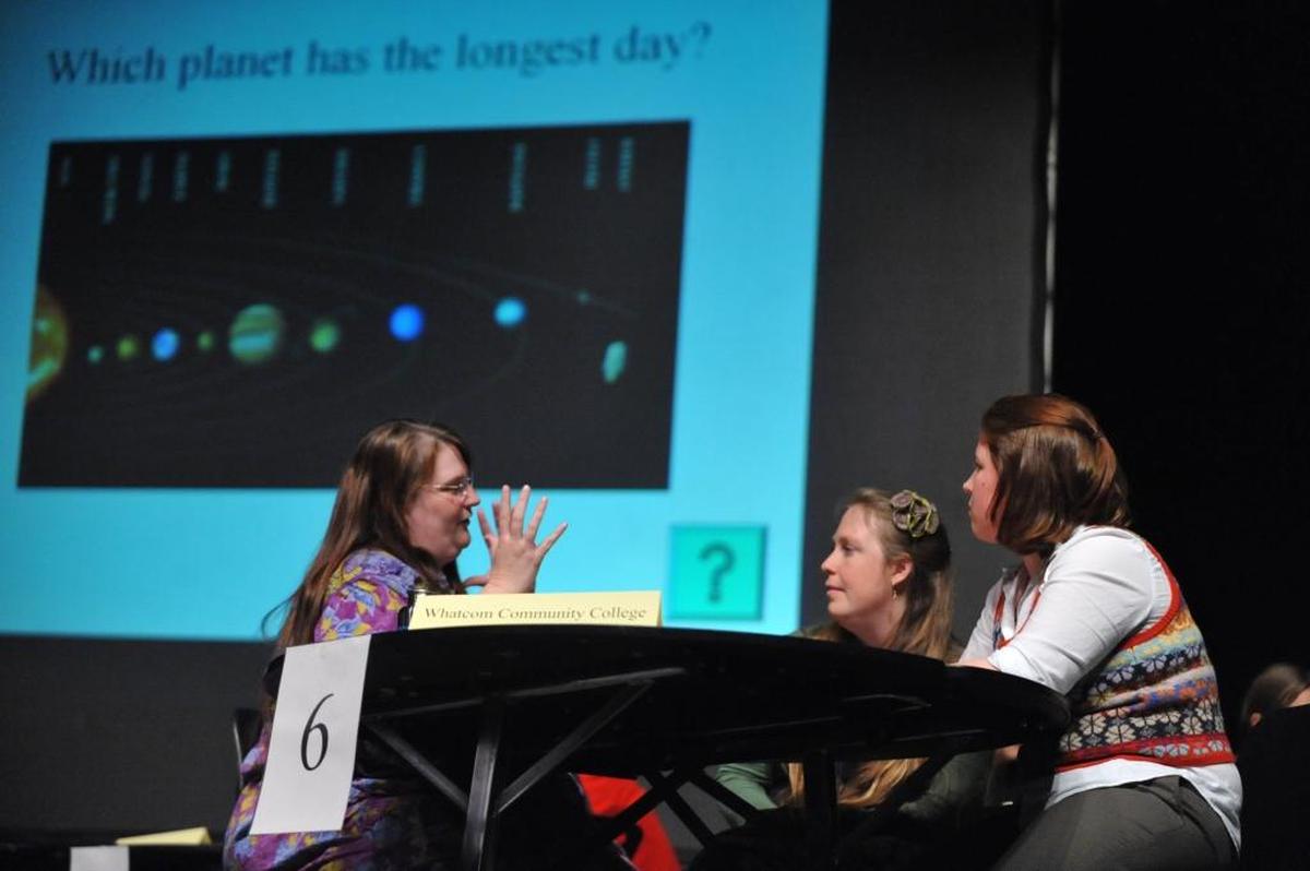 The team from Whatcom Community College discusses answer to a question at the Trivia Bee in 2011.