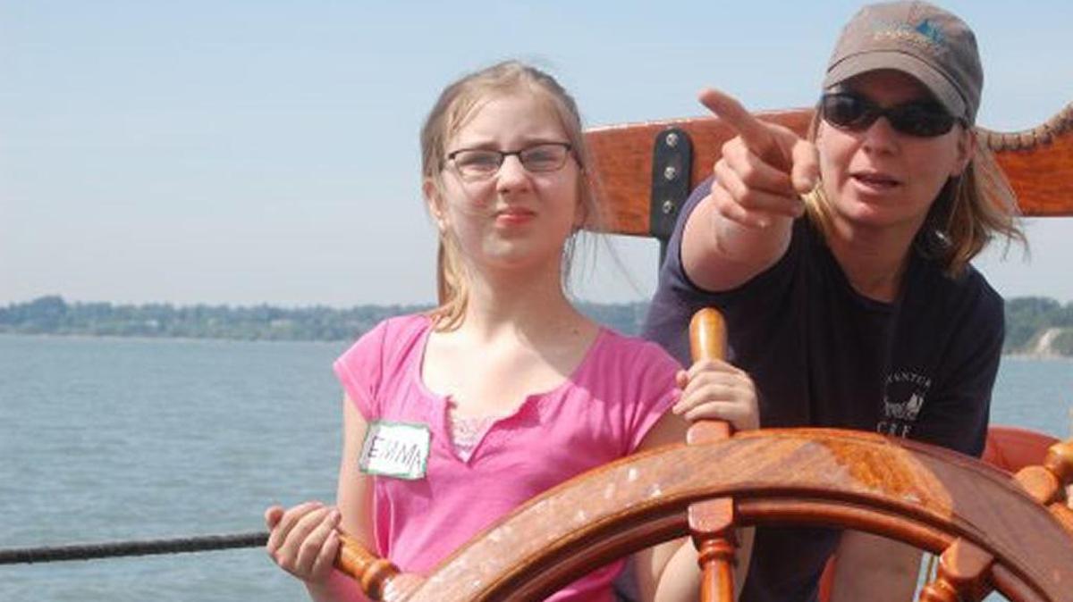 Adventuress Capt. MB Armstrong directs Emma Mittendorf at the helm during a spring 2009 trip with Geneva Elementary School.
