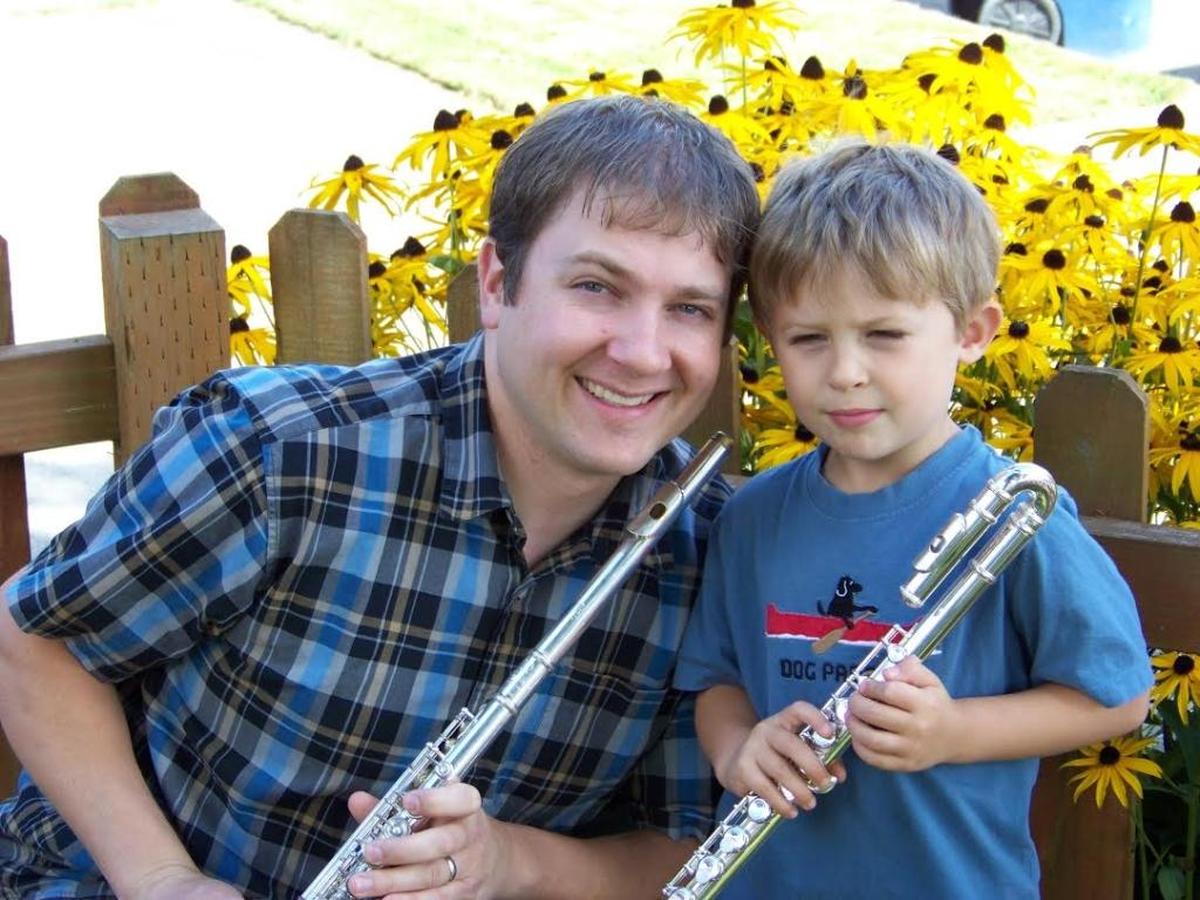 David Zagelow, left, and his son Gavion Zagelow pose with different kinds of flutes.