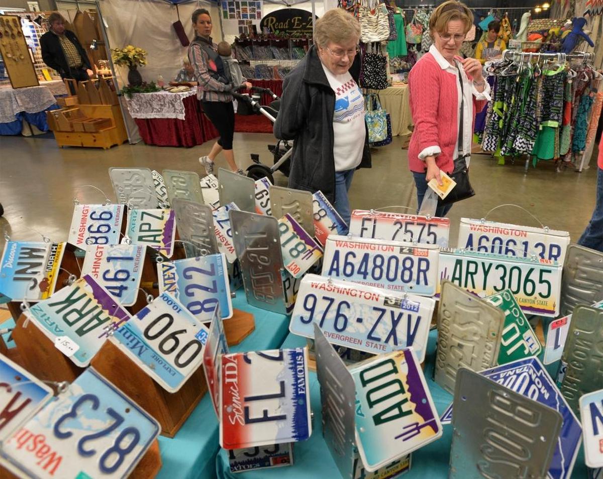 Beverly Lafeen, left, and her daughter Shirley Obermeier browse a display of license-plate birdhouses during the annual Craft & Antique Show at the Northwest Washington Fair & Event Center in Lynden in 2014.