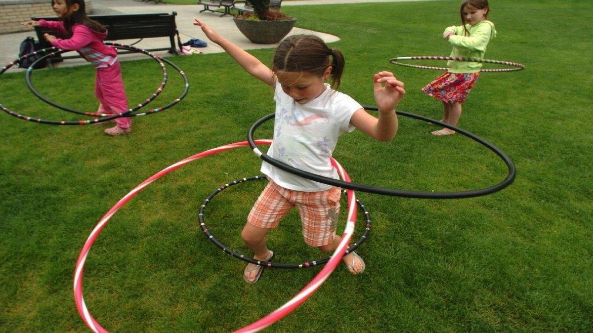 
Katie Vopnford, then 6, of Lynden, center, uses several hula hoops at the same time as she participates with Allison Kaneshige, 8, left, and LilliAnne Norman, 8, both of Bellingham,and others at the Hopscotch & Hula Hoops event at Bellingham Public Library in 2007. This year’s event will be noon to 2 p.m. Friday, July 24. 
