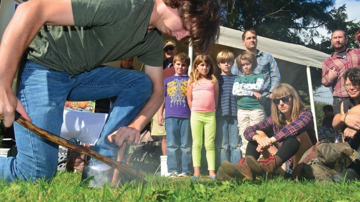 Charlie Borrowman demonstrates how to start a fire using friction at the Skillshare Faire in 2013 at Hovander Homestead Park in Ferndale. Hundreds of people watched demonstrations on water witching, beer brewing, bow making and other skills.