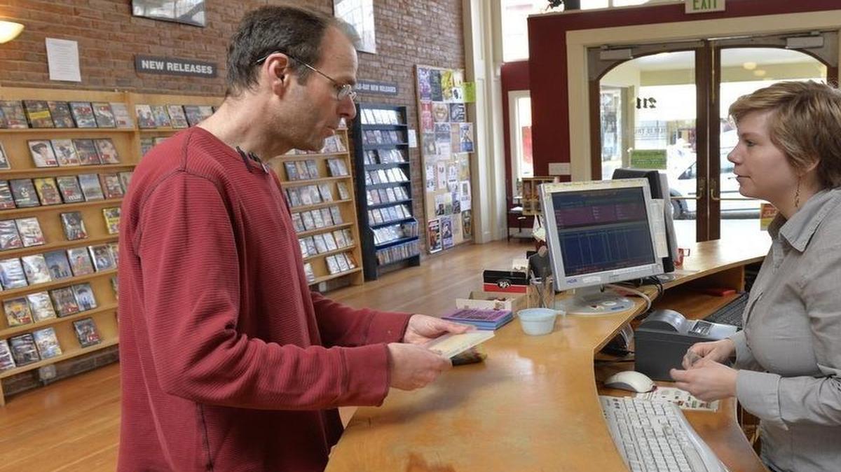 
Customer Joe Gibson of Ferndale rents a movie from manager Dee Dee Chapman at Film is Truth in downtown Bellingham on March 27, 2015. The video rental store is transitioning from a company to a nonprofit.
