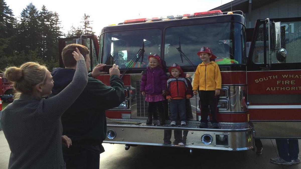 
Parents take photos of their children after a fire engine tour at the 2014 pancake breakfast at Geneva Fire Station.
