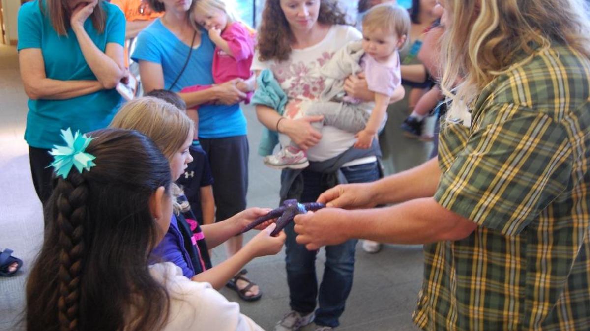 
Padilla Bay nature center aquarist Mark Olson shows a sea star to visitors during an aquarium tour in August
