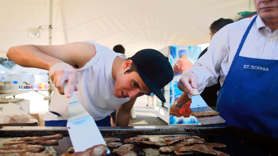 
George Karadimas, left, checks gyro meat while cooking with Andy Webster at the 2014 Greek Festival. The 2015 festival runs Sept. 10-13 at St. Sophia Greek Orthodox Church.
