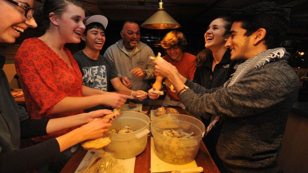 Members of the 2012 Squalicum High School Rotary Interact Club race each other while breaking up bread for stuffing at Old Town Cafe for the cafe’s annual Thanksgiving Day meal. The 2015 free meal is 9:30 a.m. to 3:30 p.m.