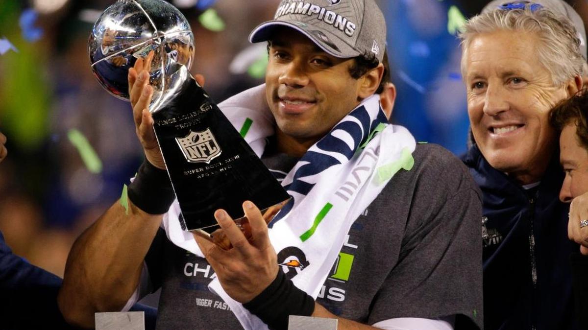 Quarterback Russell Wilson hoists the Lombardi trophy after a 43-8 victory against the Denver Broncos in Super Bowl XLVIII in 2014. The Carolina Panthers and Denver Broncos will meet in Super Bowl 50 on Sunday, Feb. 7.