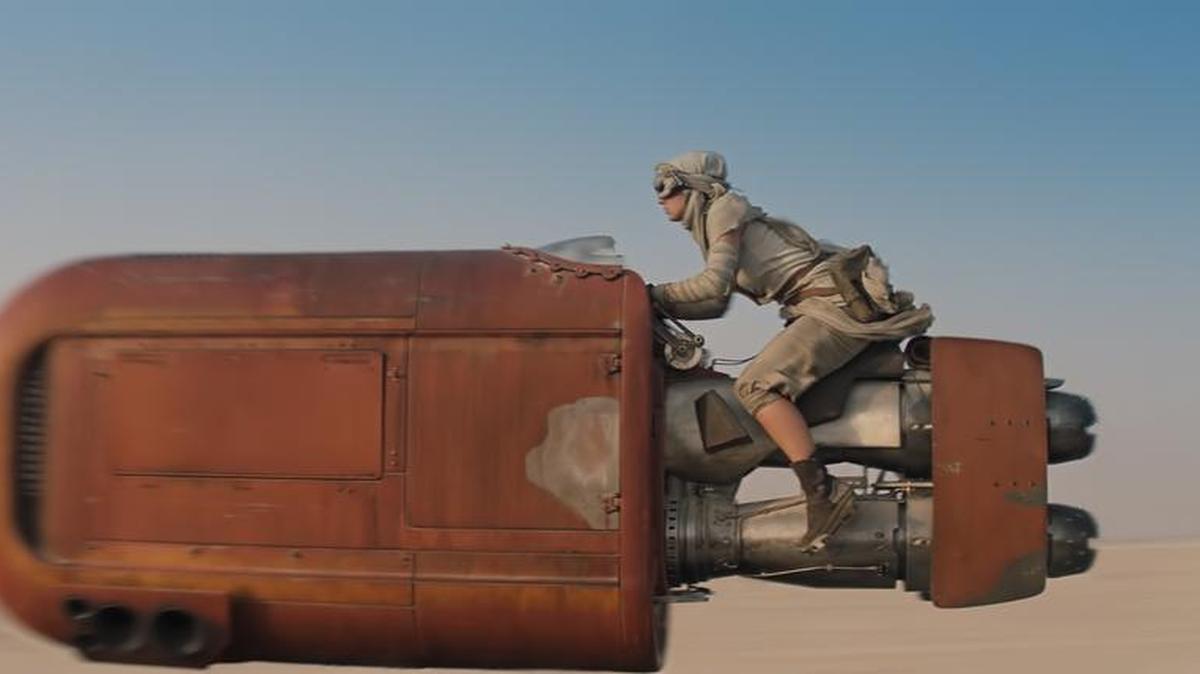 Rey (Daisy Ridley) zips over the Jakku desert in “Star Wars: The Force Awakens.”