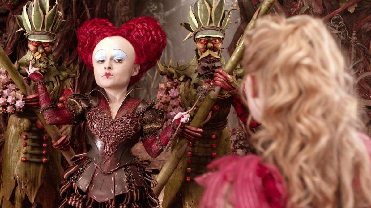 Helena Bonham Carter, left, plays the Red Queen and Mia Wasikowska has the title role in “Alice Through The Looking Glass.”