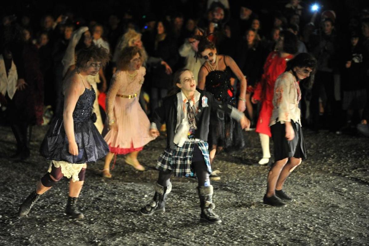 Zombies walk out from the crowd as they get ready to perform at the Thrillingham show in the Fairhaven parking lot in 2010. 