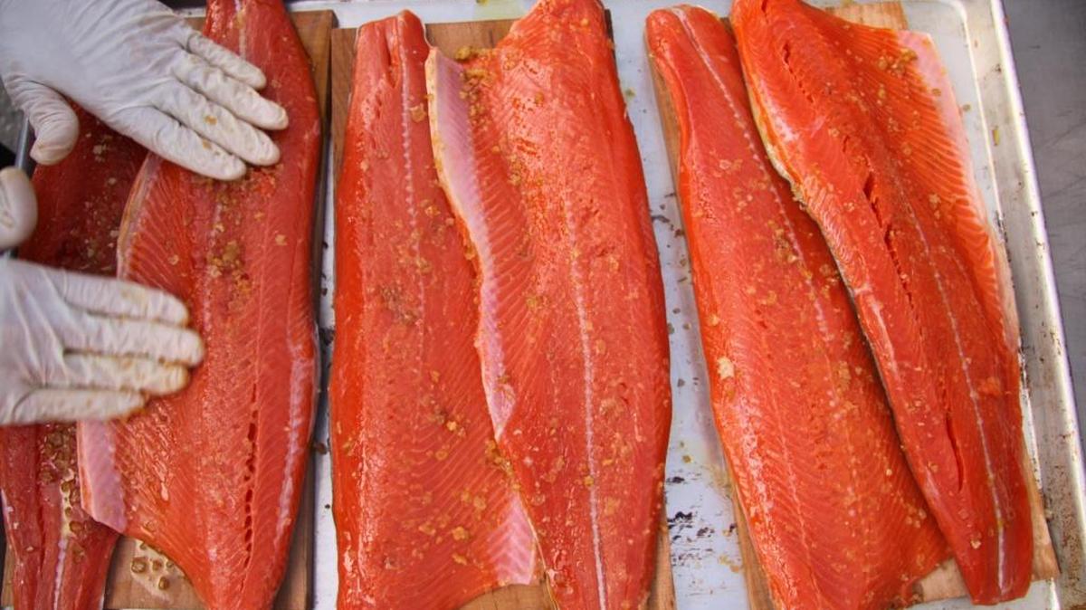 Many Alaska families celebrate Christmas with a feast featuring salmon. In this 2011 file photo, salmon planks are prepared for the Business Alliance for Local Living Economies event in Fairhaven.