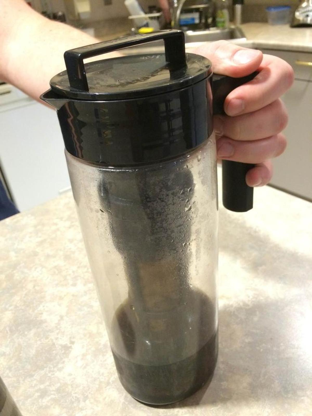 A container with a gold filter is used for cold-brew coffee.