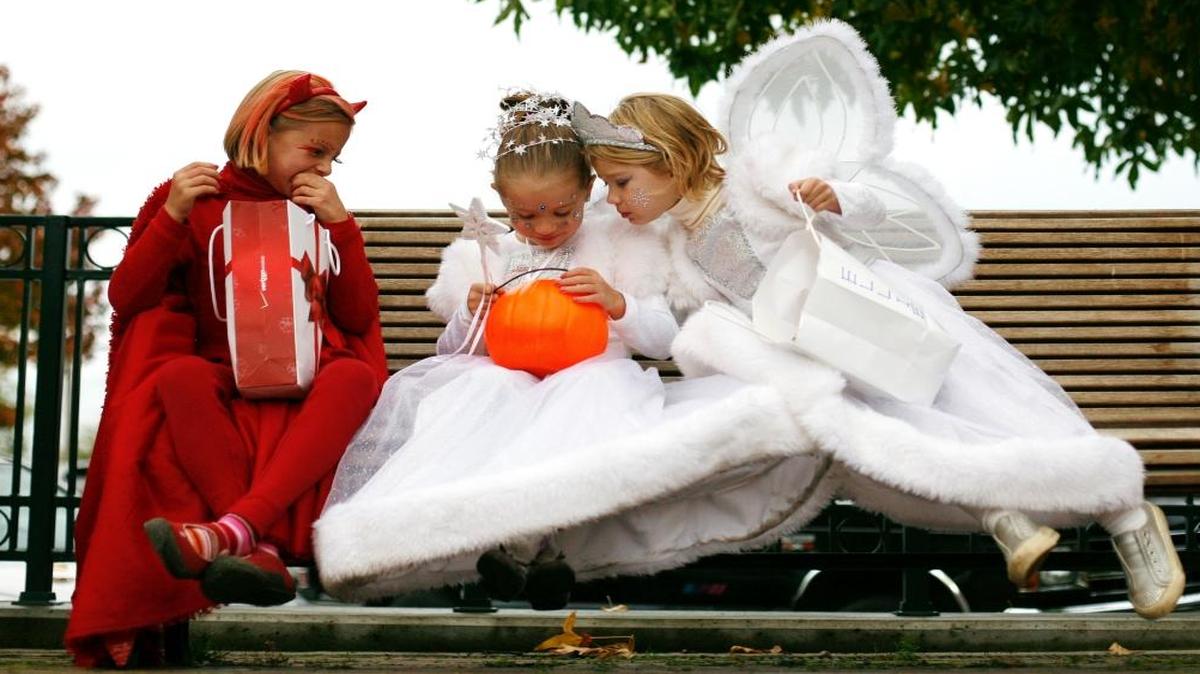 
Devil Claire Campbell, then 7, along with angels Maia Killian, then 5, middle, and Ellie Osterloh, also then 5, check out their haul of candy in Fairhaven Park on Oct. 31, 2008. They were among the hundreds of kids and parents who dressed up to trick-or-treat in Fairhaven. Favorite, and not so favorite, Halloween candies often become a lasting memory for children as they grow into adulthood.
