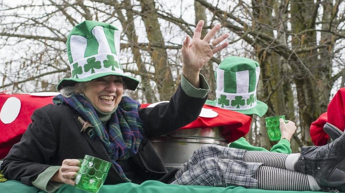 Mari Kemper waves to spectators from the Chuckanut Brewery float during the 2016 Bellingham St. Patrick's Day Parade. The 2017 parade is March 11.