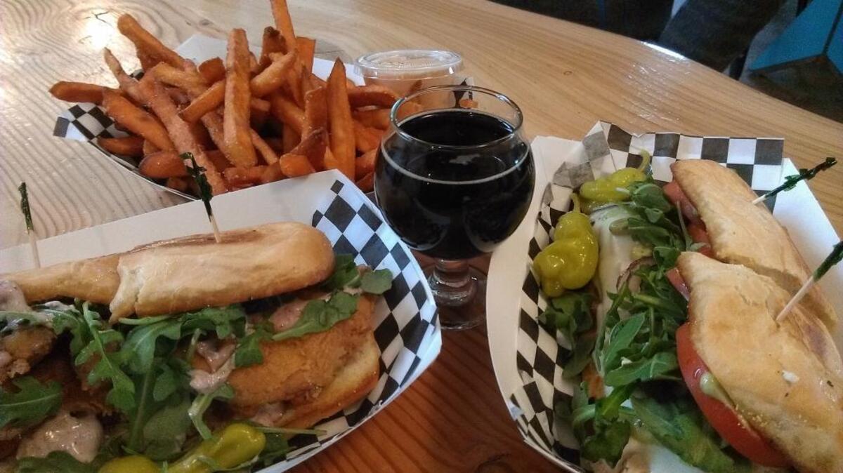 The Greek (left) and Basil Bird sandwiches with sweet potato fries from Deli’cious Mischief in Bellingham.
