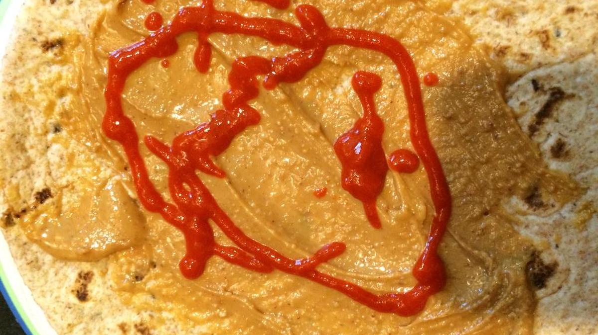 
A whole-wheat flatbread or tortilla with peanut butter and Sriracha makes a great snack, reminiscent of a more complex Asian peanut sauce.
