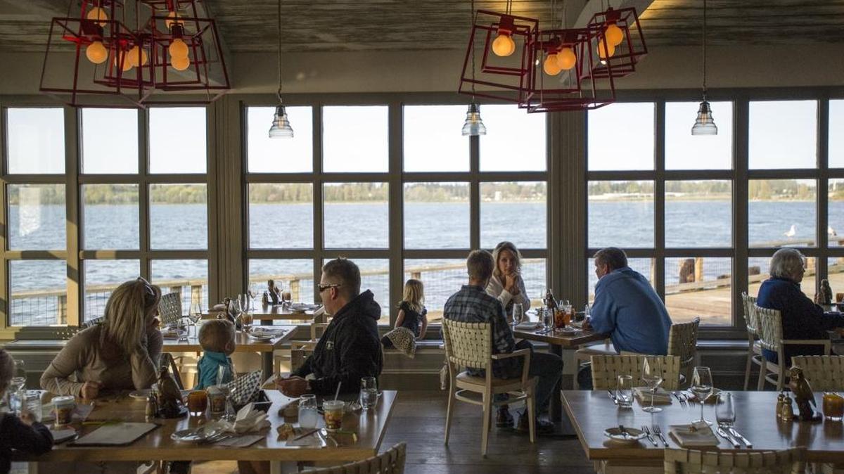 Diners are surrounded by windows looking out onto Semiahmoo Bay from one of the restaurants at Semiahmoo Resort.