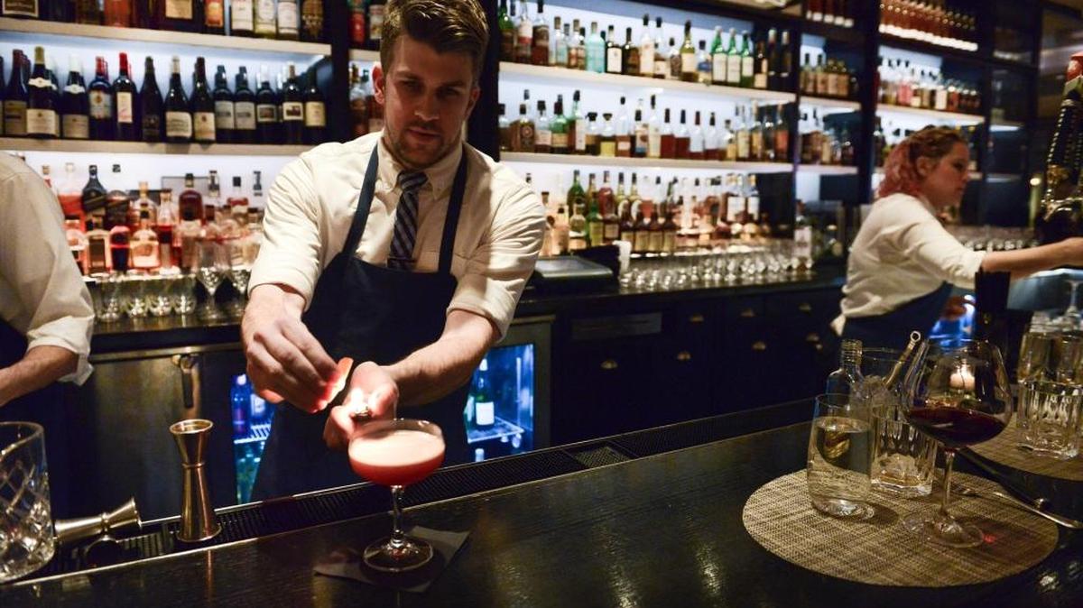 Bartender makes a drink in January, 2015, at New York’s North End Grill, one restaurant to switch to a no-tipping system. The day may come when you won’t have to figure out what 15 percent to 20 percent of your check is at the end of a meal, but the earliest experiments in eliminating tipping at American restaurants have proved to be less than conclusive.