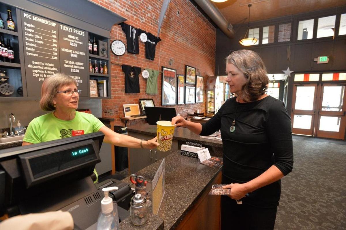 Alice Clark, former executive director of the Pickford Film Center, gets a cup of GMO-free popcorn from volunteer Diane Blake in 2013. The film center is now offering three beer draft lines – Boundary Bay’s IPA and Scotch Ale, as well as Wander's Uncommon; taps will be rotating throughout the year.