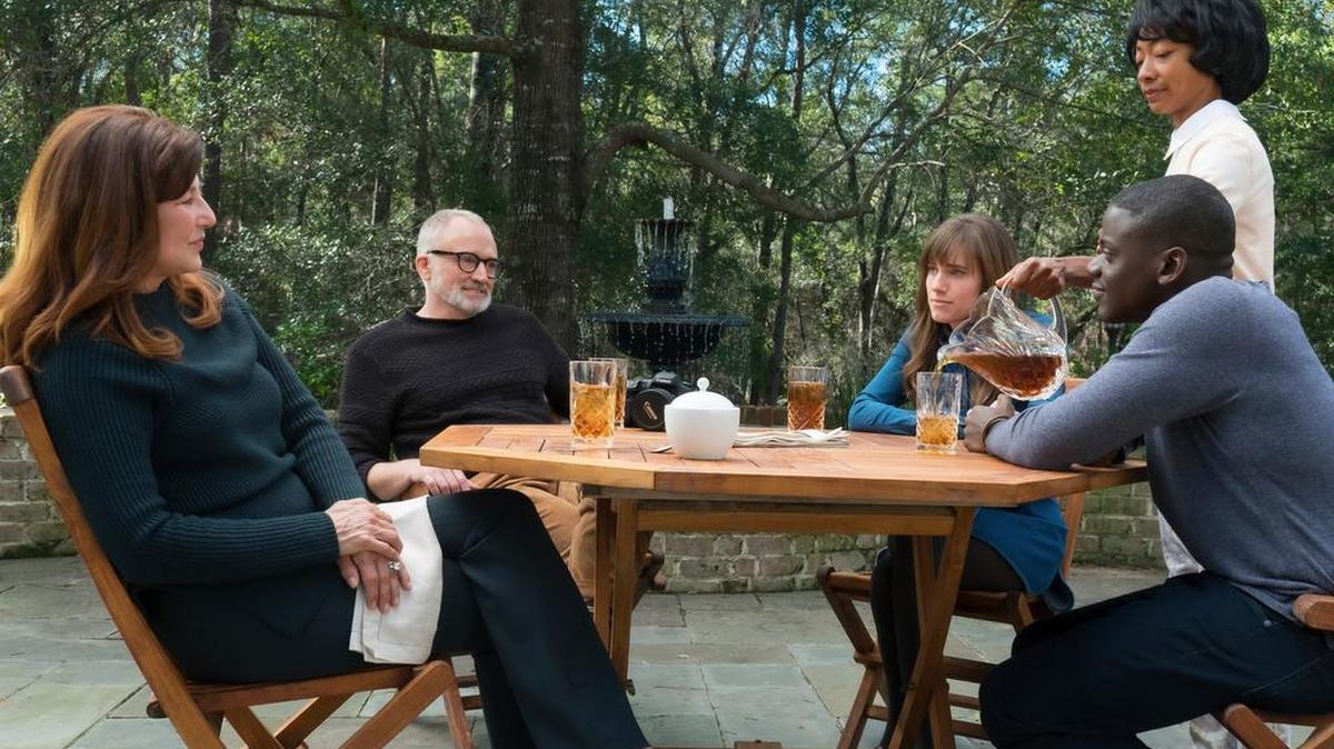 From left are Catherine Keener, Bradley Whitford, Allison Williams, Betty Gabriel and Daniel Kaluuya in a scene from Jordan Peele’s “Get Out.”