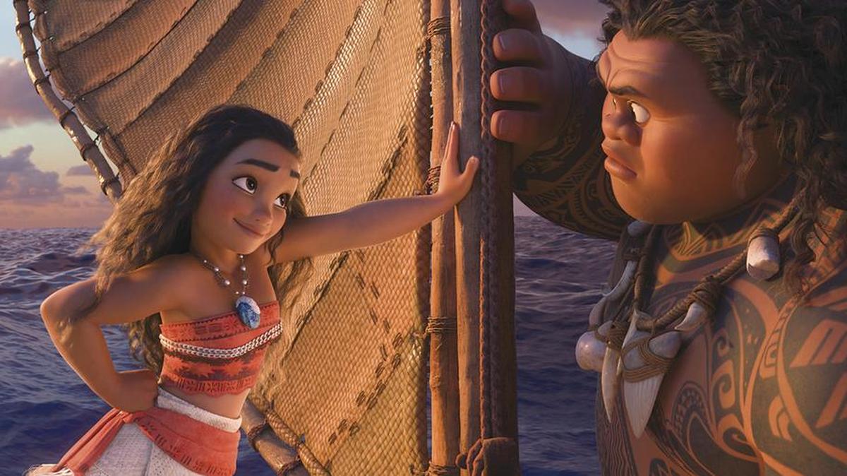 Moana, left, voiced by Auliʻi Cravalho, recruits a demigod named Maui, right, voiced by Dwayne Johnson, to help her become a master wayfinder and sail out on a daring mission to save her people.