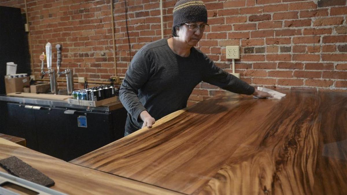 John Quimod, co-owner of the Peace Arch City Cafe, wipes down the bar at the new location of the cafe, the former Pastime Bar and Eatery on Peace Portal Drive in Blaine, Tuesday, Oct. 24. The cafe now serves breakfast, lunch and dinner.