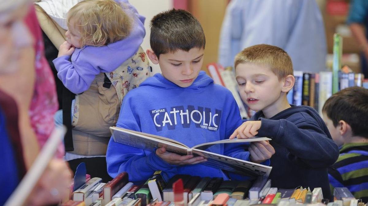Children examine a book on whales at the Friends of the Bellingham Public Library sale in March 2015.