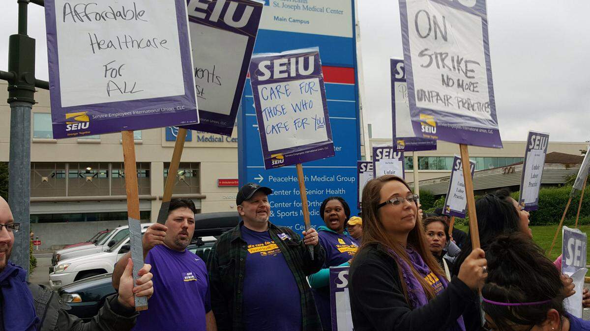 Striking workers at PeaceHealth St. Joseph Medical Center and its labs picket in Bellingham, Washington in 2015.