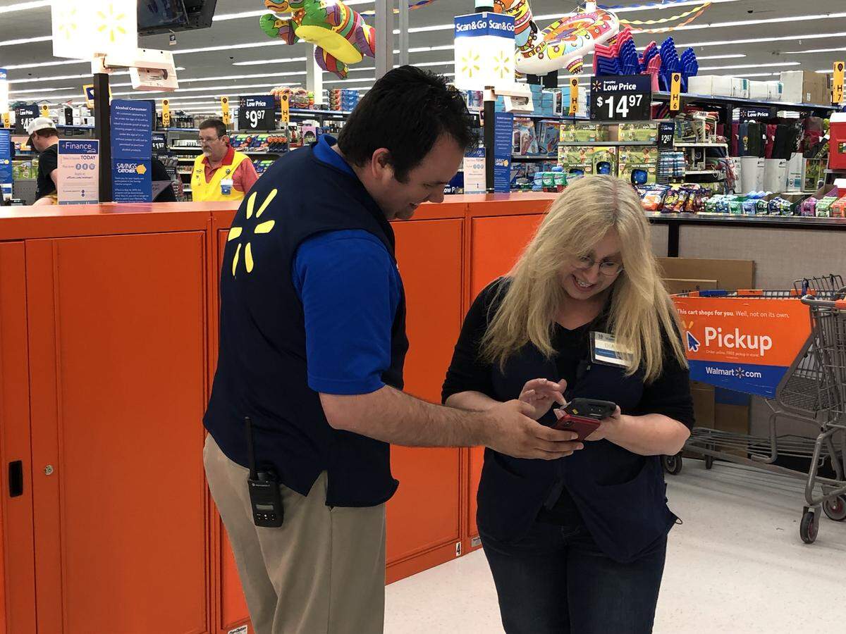 Bellingham Walmart Store Manager Chris Johnson and Site Store Associate Diane Whitman look over some online product pickup information on Thursday. The store recently completed a major remodel that includes expanding its online ordering department. Shoppers can shop for items online and pick it up at the front of the store.