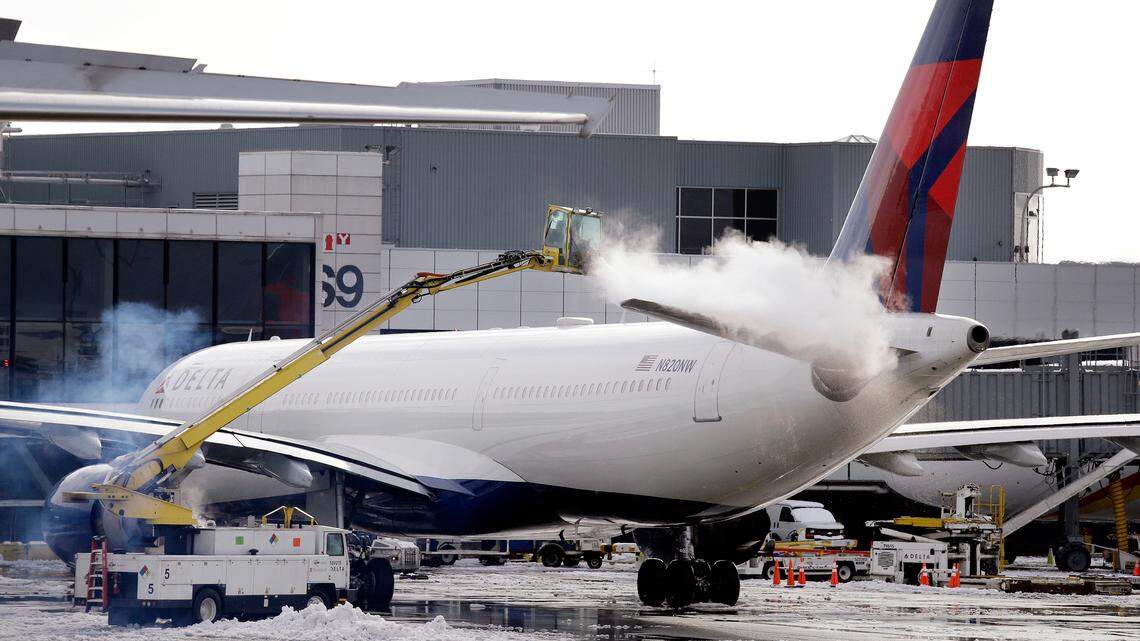A deicing agent is sprayed on a jet at Seattle Tacoma International Airport in 2017, in SeaTac, Wash. With limited space as the airport is hemmed in by neighboring cities, staff have had to get creative in finding places to de-ice planes.