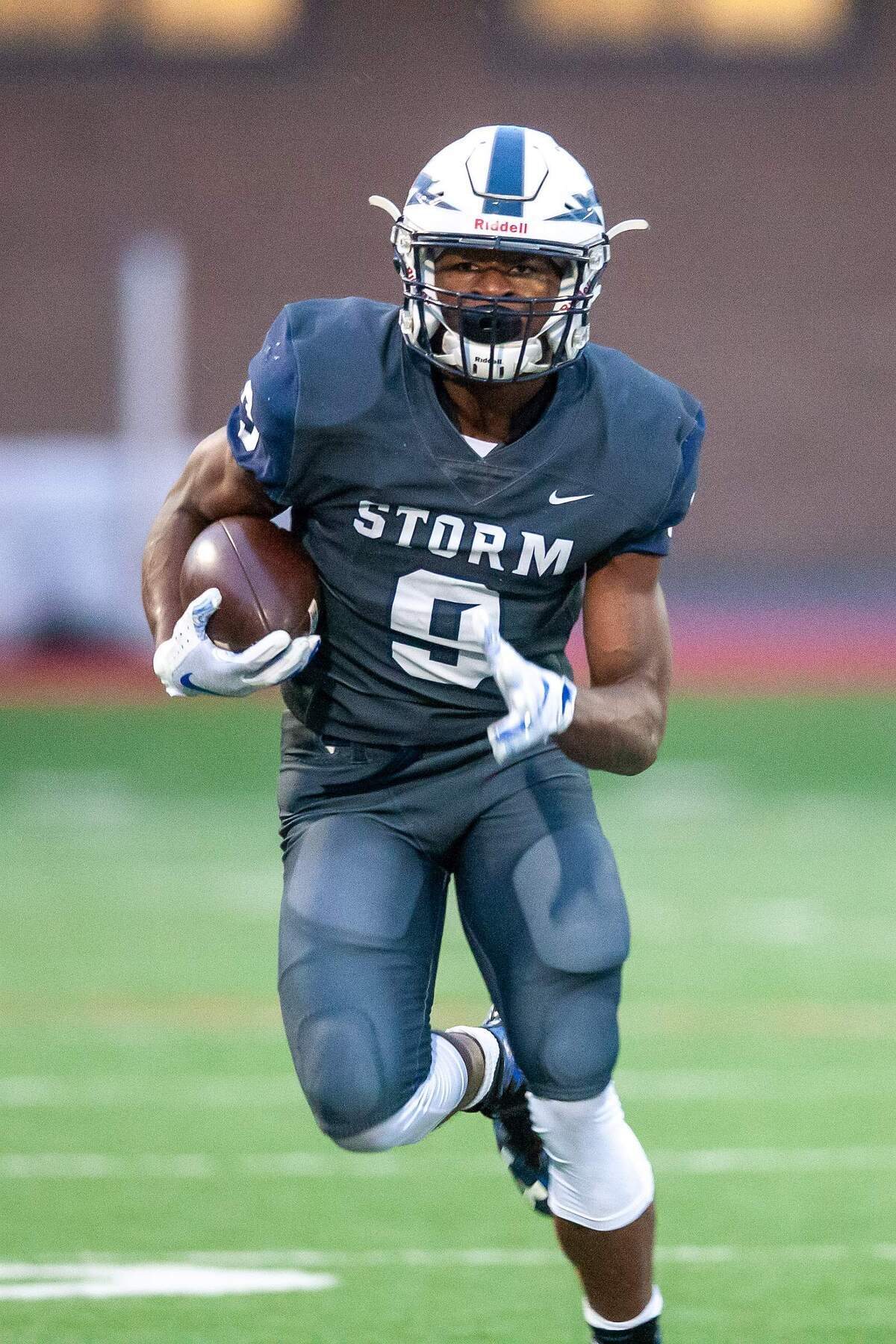 Squalicum sophomore Ben Schlenbaker picks up yardage against Ferndale on Oct. 12. Schlenbaker, a native of Haiti, has emerged as a standout for the Storm, both because of what he accomplishes on the football field and what he does off it.