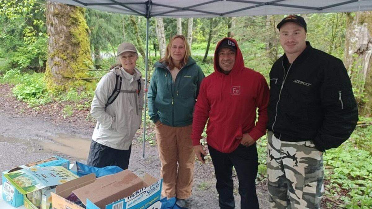Steve Avila, in red hoodie, with volunteers, from left, Lori Jo Erclichman, Ann Crampton and Gerron Syvertson at a trail watch in early May at the Pine and Cedar Lakes trailhead near Bellingham.